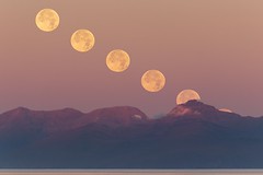 September supermoon setting behind Isle of Rum, Scotland