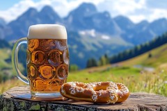 Bier und Brezel vor Berglandschaft