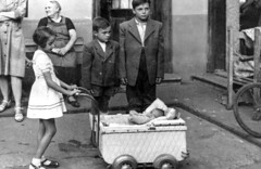 Vintage photo of children with a baby in a stroller, Hungary 1950s