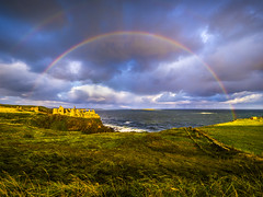 Rainbow Dramatic Light Stormy Skies Dunluce Castle Sunrise Bushmills Northern Ireland County Antrim Fuji GFX100s Irish Sea Cliffs Fine Art Medium Format Photography IE! Elliot McGucken Master Fine Art Landscape Photographer Beautiful Views and Scenery