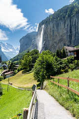 Summer landscape of famous alpine village Lauterbrunnen with famous church and Staubbach waterfall. Berner Oberland, Switzerland, Europe