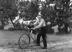 Vintage outdoor photo of a father and child on a bicycle, Hungary, 1930s