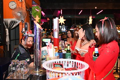 DSC_7331: a group of people standing around a bar