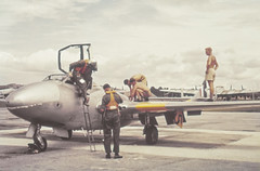 Pilots exiting RNZAF 14 Squadron Vampire T11 XH358, probably at Bangkok Airport for the SEATO exercise Air Link. RAAF Lincolns are visible in the background.