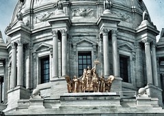 Minnesota -  Quadriga. The gleaming gold sculpture is the Quadriga, the Latin word for a four-horse chariot. It was designed by Daniel Chester French and Edward C. Potter, and it is made of sheets of gilded copper hammered around a steel frame  Twin Citie