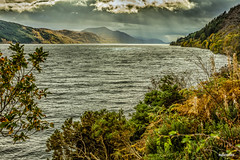 Loch Ness with Autumn colours and under moody skies, nearing sunset. Taken from half way between Urquhart Castle and Invermoriston, Inverness-shire, Scotland.
