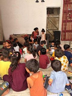 Blue pen's volunteer and coordinator manju mandal teaching basic hindi to slum kids of 1st grade in harkesh nagar.